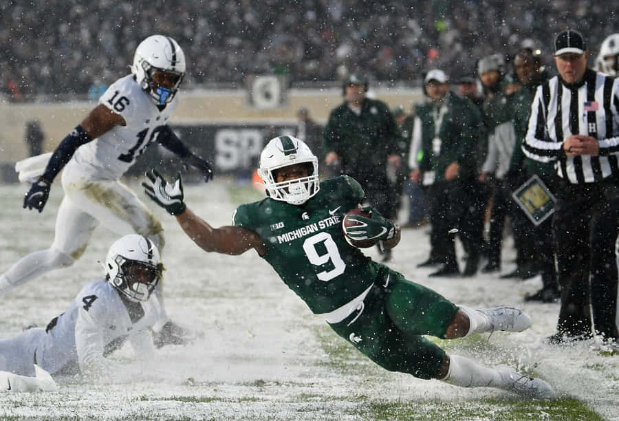 Snowy_ Football_ Game_ Action Wallpaper