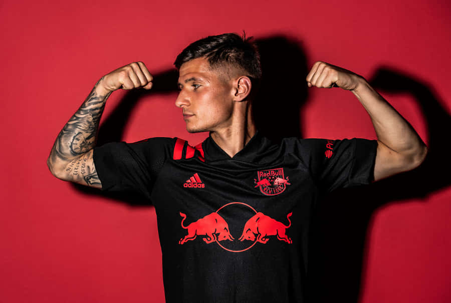 Soccer Player Flexingin Red Bull Jersey Wallpaper