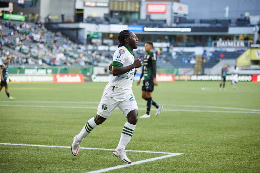 Soccer_ Player_in_ Action_on_ Field.jpg Wallpaper