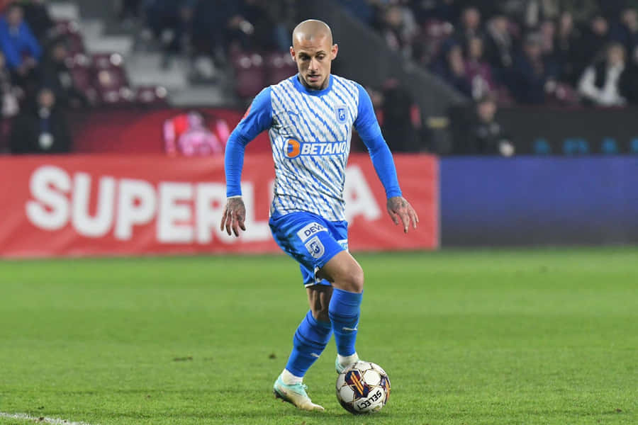 Soccer_ Player_in_ Action_on_ Field.jpg Wallpaper