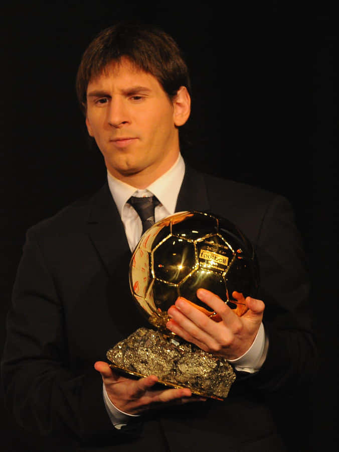 Soccer Player With Ballon Dor Trophy Wallpaper