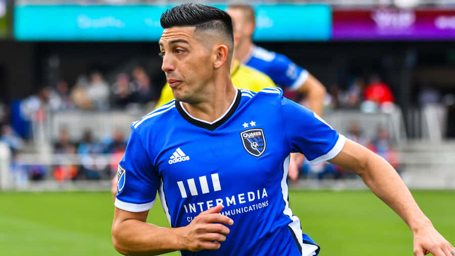 Soccer Playerin Blue Jersey Action Shot Wallpaper