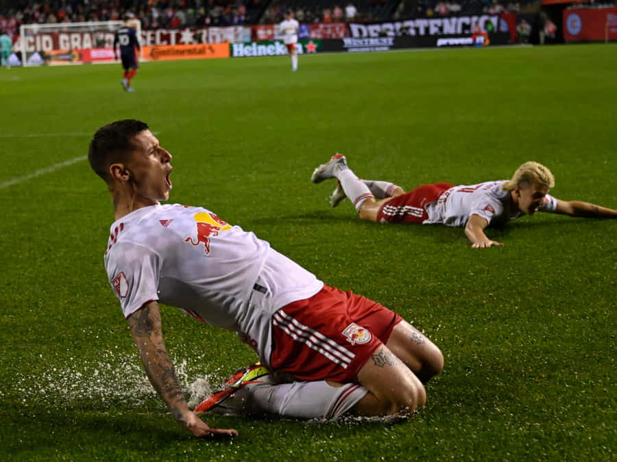 Soccer Players Celebrationon Field Wallpaper