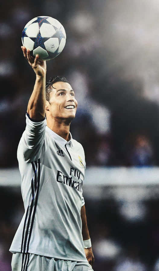 Soccer_ Star_ Holding_ Ball_ Victory_ Pose.jpg Wallpaper