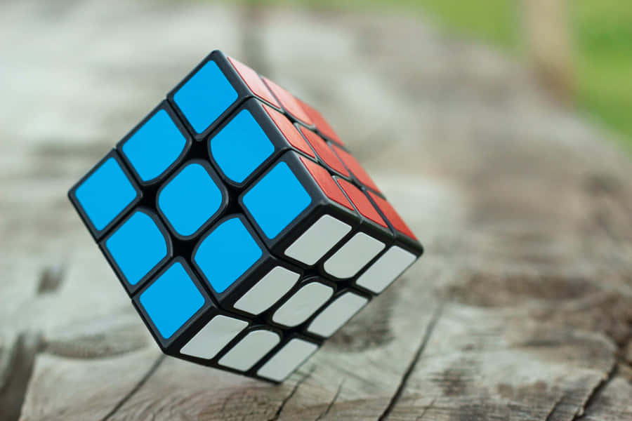 Solved Rubiks Cubeon Wooden Background Wallpaper