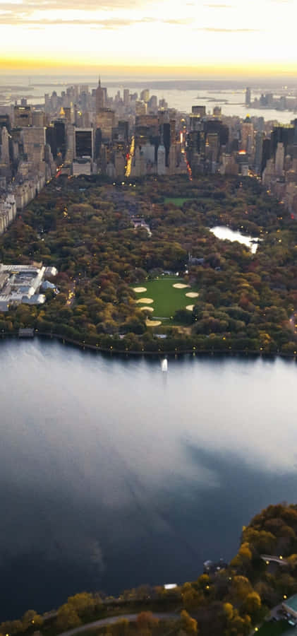 Spectacular Landscape Featuring Rolling Meadows And A Beautiful Orange Sky Wallpaper