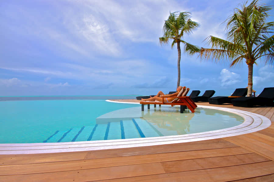 Splendid Beach Swimming Pool With Crystal Clear Waters Wallpaper