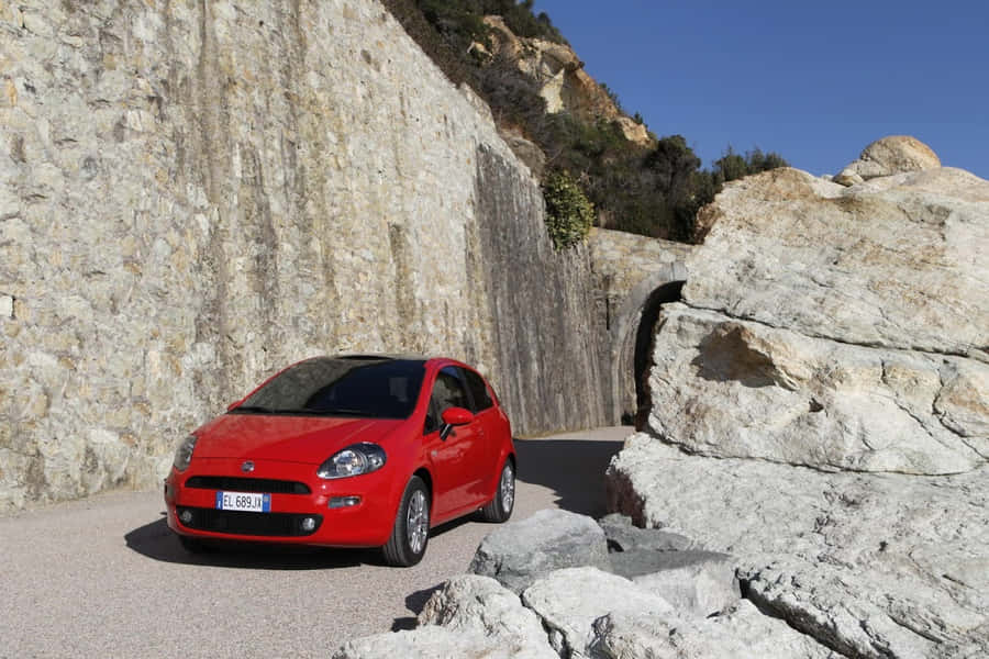 Sporty Fiat Punto In Scenic Landscape Wallpaper