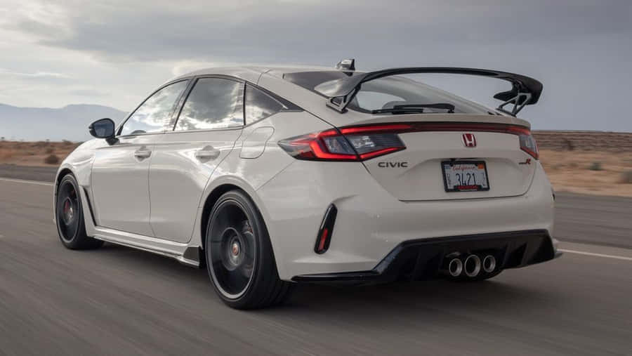 Sporty Hatchback On A Scenic Road Wallpaper