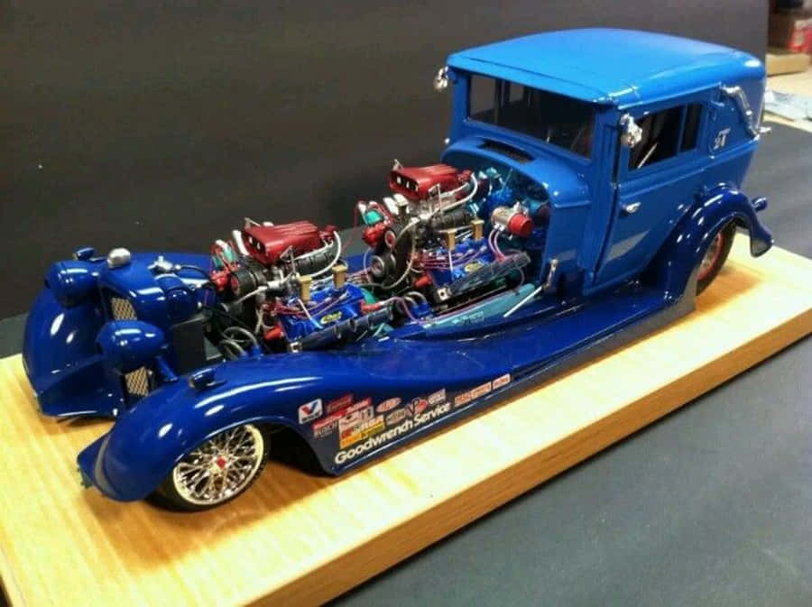 Sporty Red Car Modelshowing Off Its Sleek Design In A Night Cityscape Wallpaper