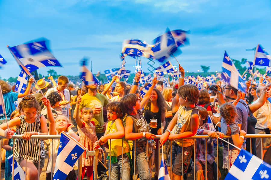St Jean Baptiste Celebration Crowd Waving Quebec Flags Wallpaper