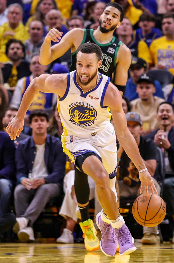 Steph Curry Dribbling A Ball During Game Wallpaper