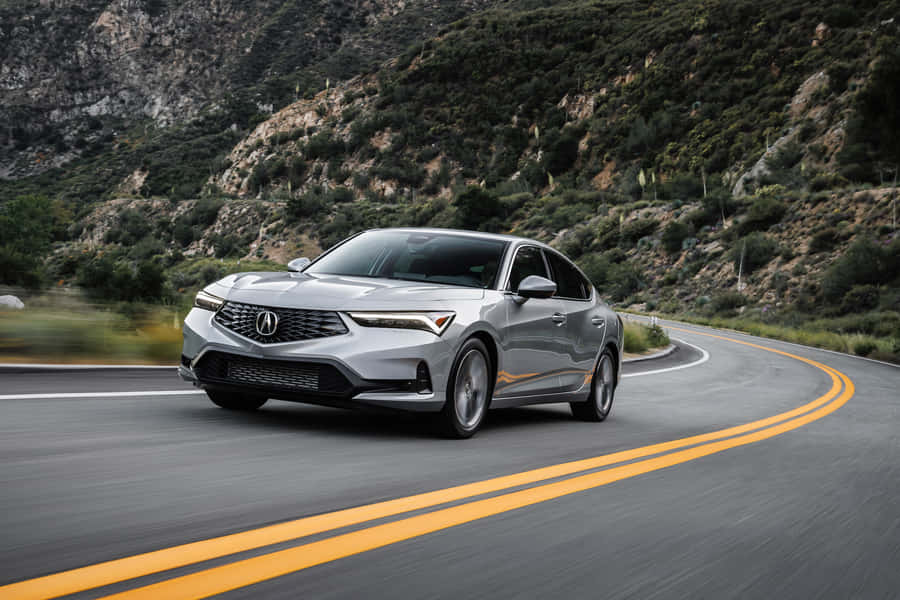 Stunning Acura Integra Sport Coupe On A Scenic Mountain Road Wallpaper