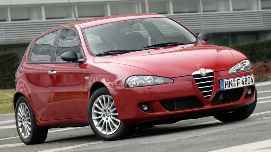 Stunning Alfa Romeo 147 On A Scenic Road Wallpaper