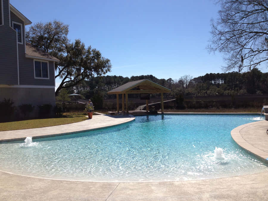 Stunning Beach Swimming Pool Overlooking The Ocean Wallpaper