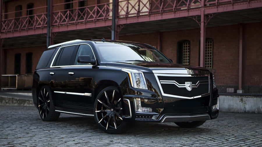 Stunning Cadillac Escalade In A Striking Urban Backdrop Wallpaper