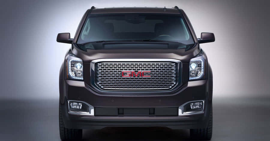 Stunning Gmc Yukon Cruising Down The Road Wallpaper