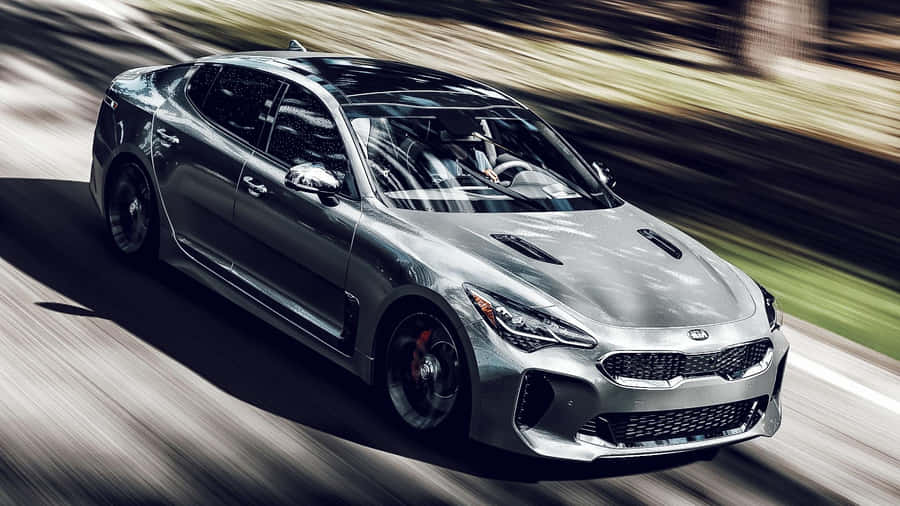 Stunning Kia Stinger In Vibrant Red On Scenic Road Wallpaper
