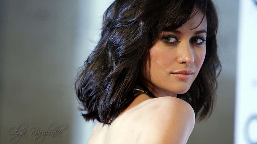 Stunning Olga Kurylenko Posing In An Elegant Outfit Wallpaper