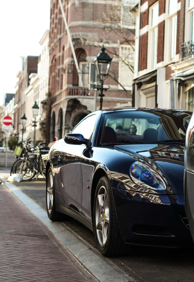Stunning Red Ferrari 612 Scaglietti On A Scenic Mountain Road Wallpaper