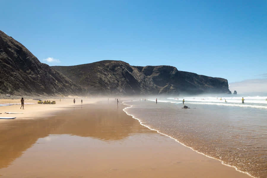 Stunning Sunset At A Tranquil Portuguese Beach Wallpaper