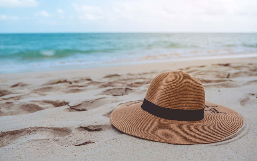 Stylish Beach Hat On Seashore Wallpaper