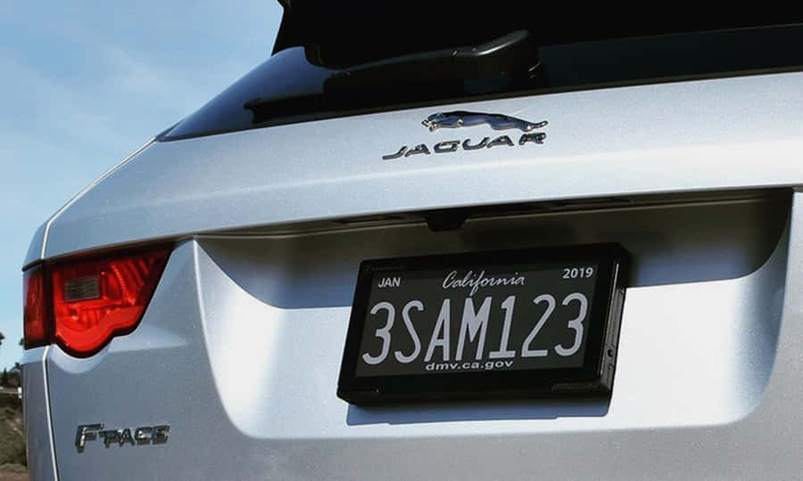 Stylish Car License Plate On A Vibrant Red Vehicle Wallpaper