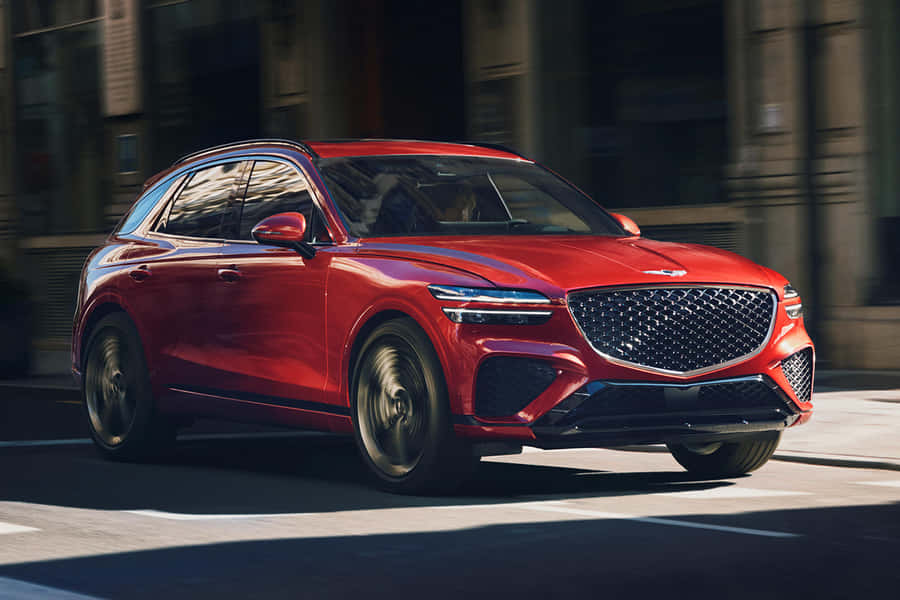 Stylish Genesis Gv70 Suv Cruising Along The Road Wallpaper