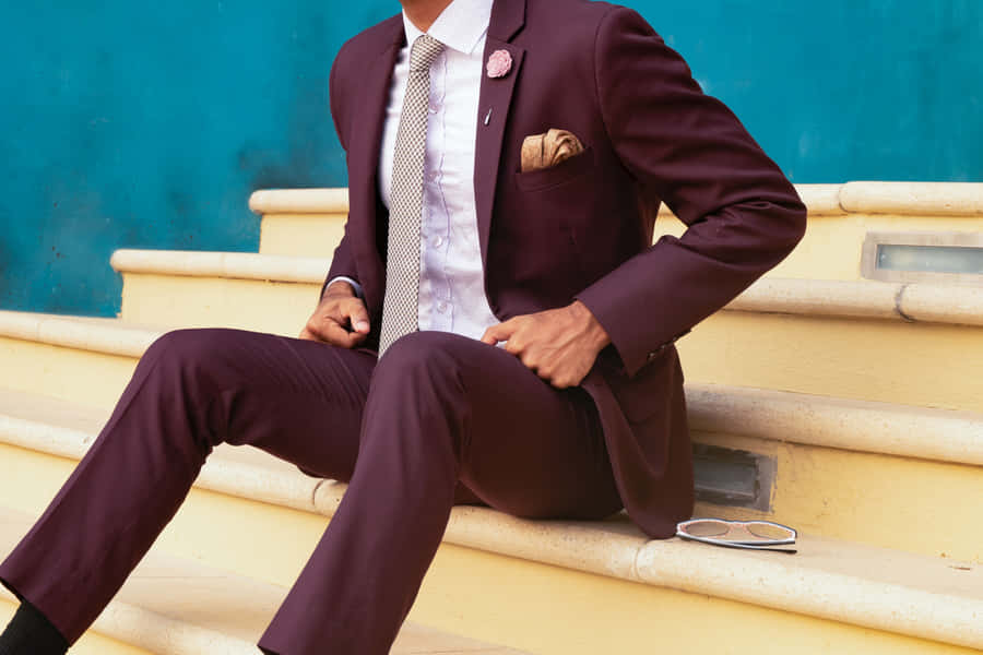 Stylish Man In Suit Posing On Yellow Stairs Wallpaper