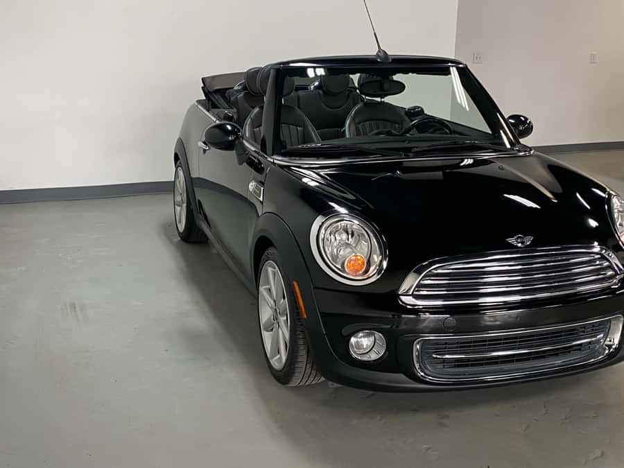 Stylish Mini Cooper Convertible Cruising Down The Street Wallpaper