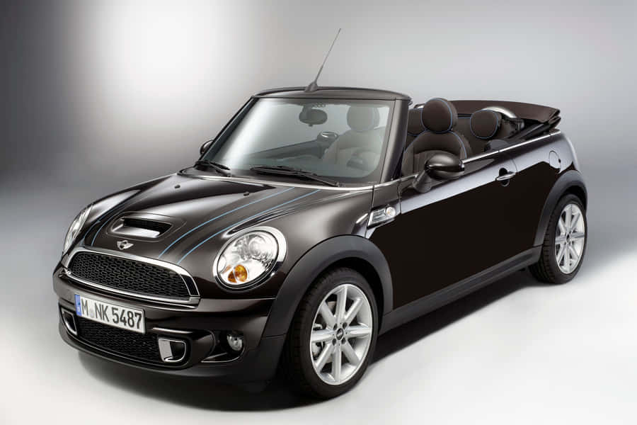 Stylish Mini Cooper Convertible Cruising In The City Wallpaper