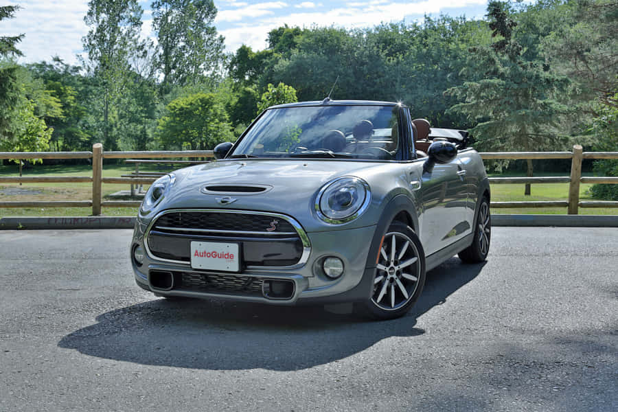 Stylish Mini Cooper S Convertible Cruising Down The Road Wallpaper
