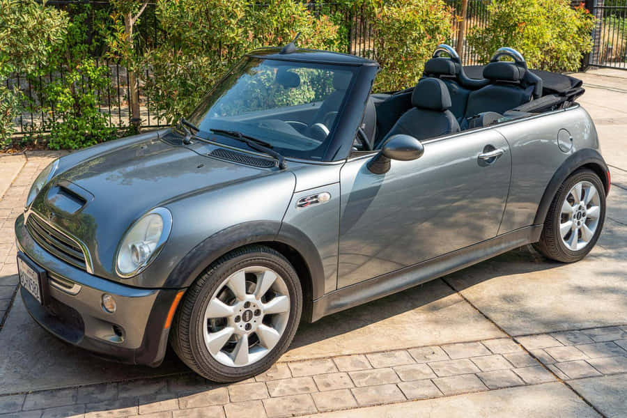 Stylish Mini Cooper S Convertible Cruising On The Open Road Wallpaper