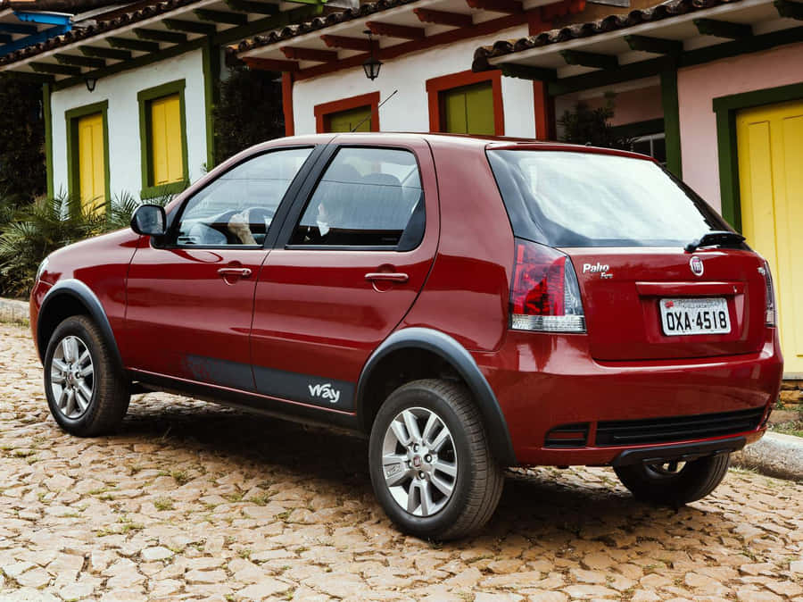 Stylish Red Fiat Palio On The Road Wallpaper