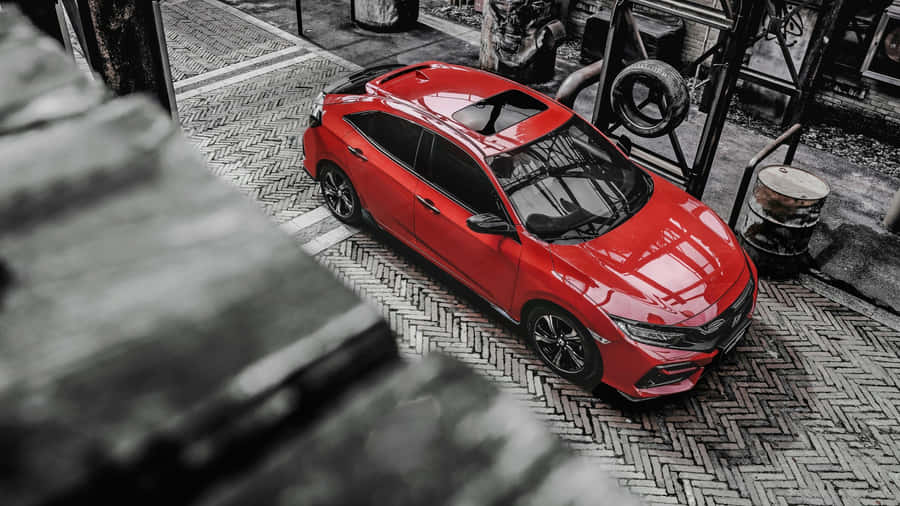 Stylish, Sleek Red Hatchback In Action Wallpaper