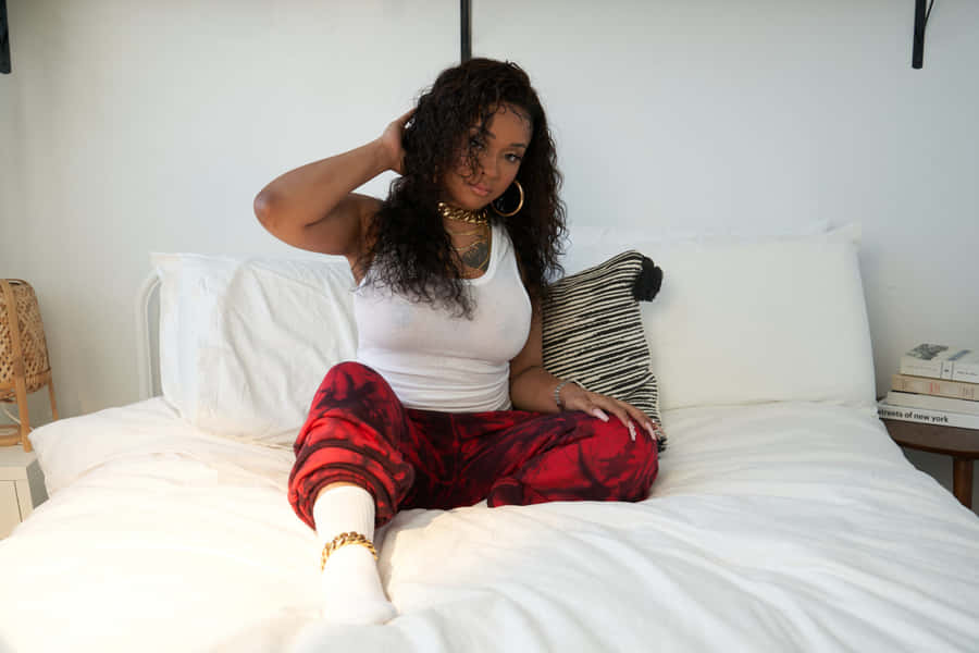 Stylish Woman Sittingon Bed Wallpaper