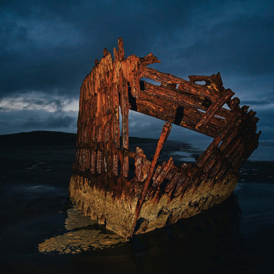 Sunken Secrets: A Stunning View Of An Old Shipwreck Wallpaper