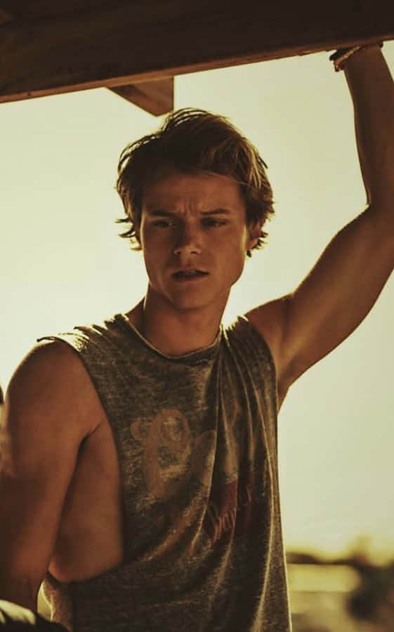 Sunlit Youth Under Beach Hut Wallpaper