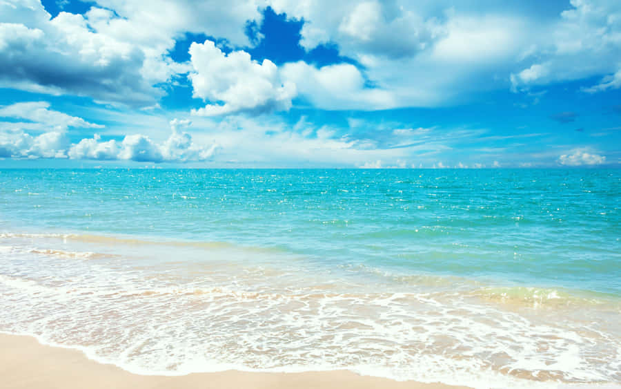 Sunny_ Beachscape_ Serene_ Waters.jpg Wallpaper