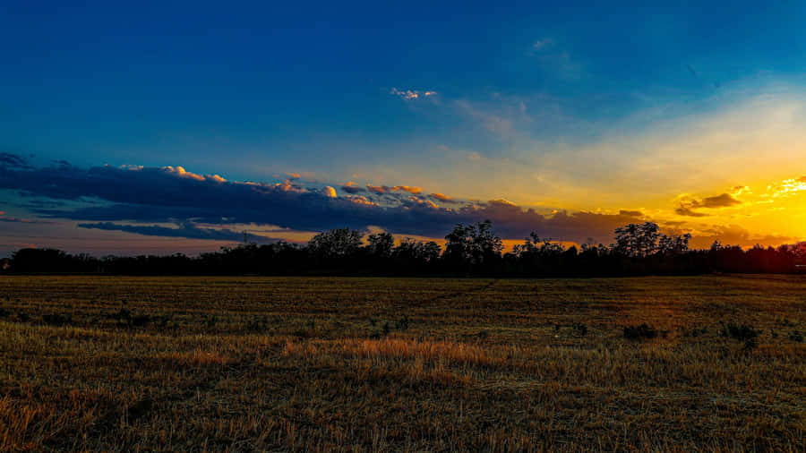 Sunset Over Open Farmland Wallpaper