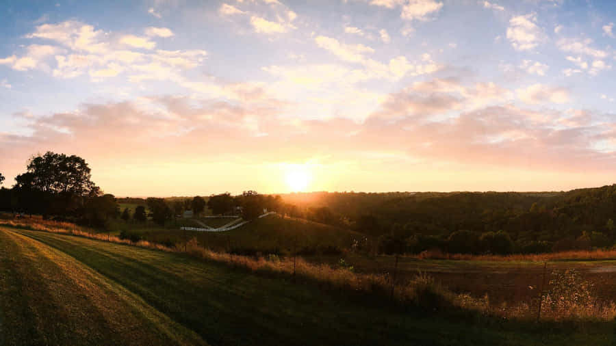 Sunset Over Rolling Farmland Wallpaper