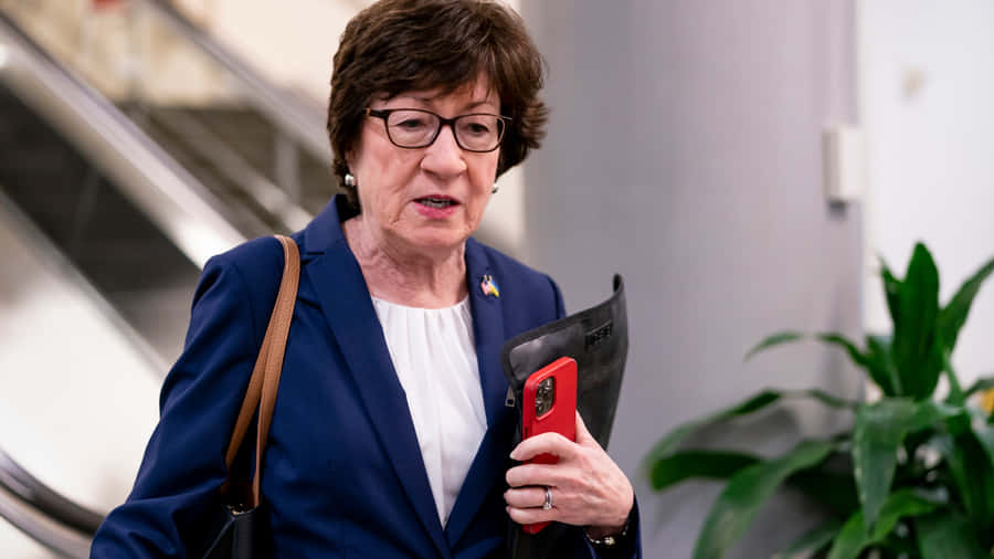 Susan Collins Holding Iphone Wallpaper