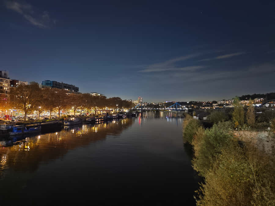 Take In The Beauty Of Night Mode And Explore The City Lights. Wallpaper