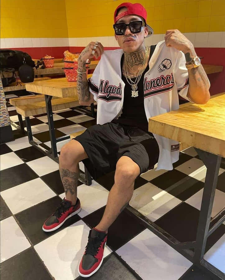 Tattooed Man Sporting Baseball Jerseyand Cap Wallpaper