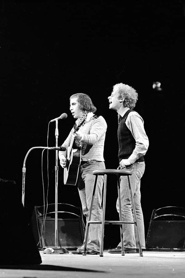 The Iconic Duo Simon And Garfunkel In The Height Of Their Career Wallpaper