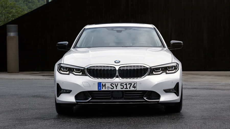 The White Bmw X3 M Sport Is Parked In Front Of A Building Wallpaper