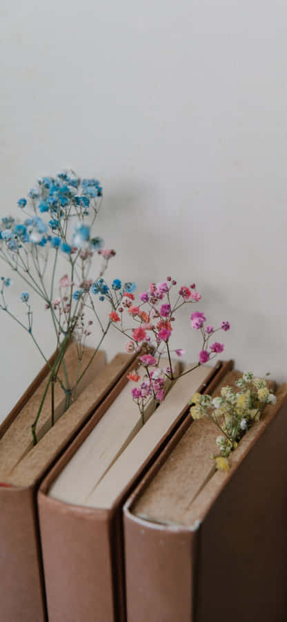 Three Books With Flowers On Them Wallpaper