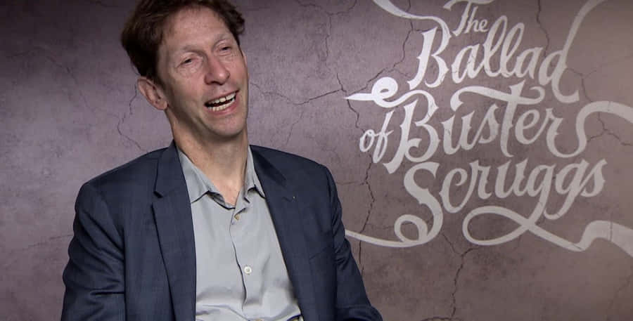 # Tim Blake Nelson Smiling During An Interview Wallpaper