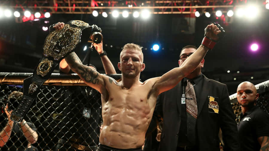 Tj Dillashaw Holding His Championship Belt Wallpaper