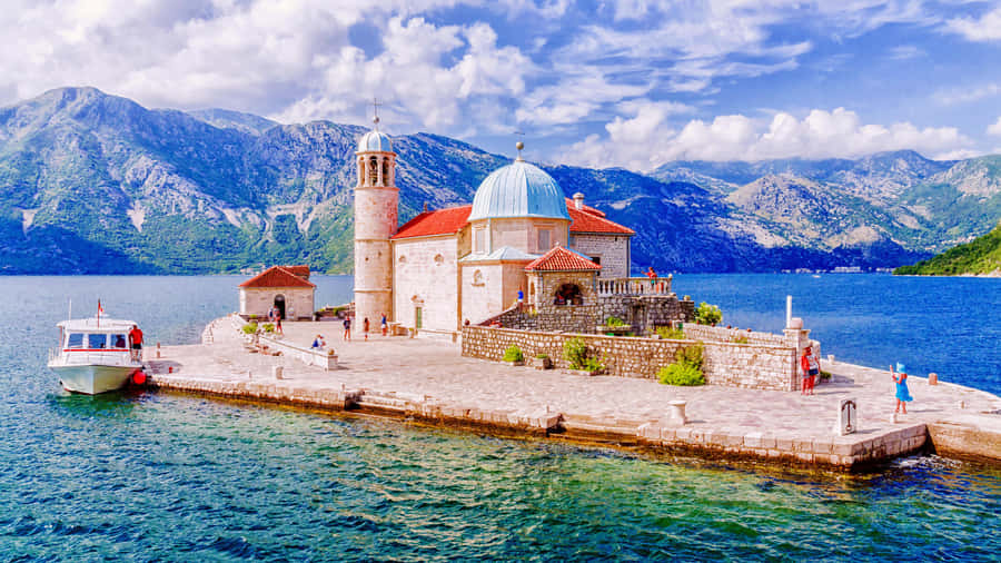 Tranquil Boat Parked At Our Lady Of The Rocks Wallpaper